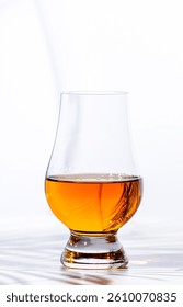 Single malt Scotch whisky in glencairn glass n white background