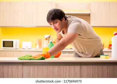Single Man Cleaning Kitchen At Home
