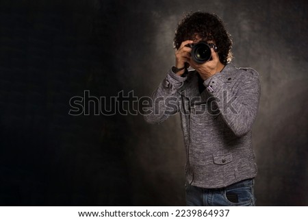 SINGLE MAN PHOTOGRAPHER MALE HOLDING CAMERA FOCUSING SHOOTING CAPTURING PHOTOS