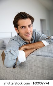 Single Man Relaxing In Sofa At Home