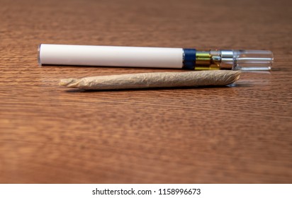 A Single Marijuana Joint And A Vape For Smoking Cannabis Oil