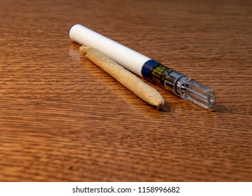 A Single Marijuana Joint And A Vape For Smoking Cannabis Oil