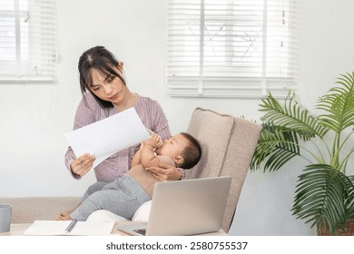 Single mom managing her workload while nurturing her baby, reviewing documents at home