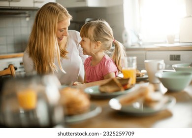 Single mother and daughter having breakfast together in the morning - Powered by Shutterstock