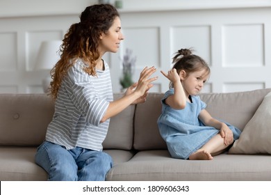 Single Mother And Little Kid Sit On Couch At Home, Parent Scolds Preschool Daughter Teaches Naughty Mischievous Child. Concept Of Punishment, Bad Behaviour Misbehave Of Infant, Upbringing Difficulties