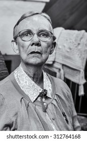 Single Old Woman In Sweater Sitting Straight