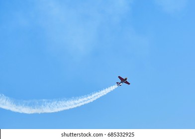 Single one sport plane of aerobatic team vapour trails in blue sky. Plane white vapour trails tracks background. Plane aerobatic maneuver stunt. Stunt planes aerobatic team vapor trails MAKS-2017 - Powered by Shutterstock