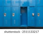 Single open empty blue metal locker along a nondescript hallway in a typical US High School. No identifiable information included and nobody in the hall.	