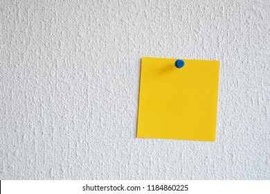 Single Orange Note Pad Reminder Attached To The Wall With Pushpin. Empty Memo Note. Orange Paper Note Tacked On A Wall.