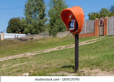 A Single, Outdated Braille Phone Booth Operates In A Distant Village On The Banks Of A Large River.