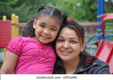 Single Parent Latin Family On Playground Closeup Tight Photograph