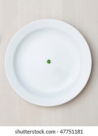 A Single Pea On A Plate