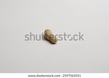 Single peanut in nutshell isolated on white