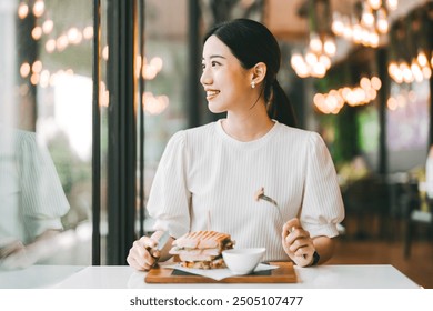 Single people relax city lifestyle concept. Adult asian woman healthy eating breakfast sandwich food diet meal. At indoors cafe restaurant on day. Happy smile face. - Powered by Shutterstock