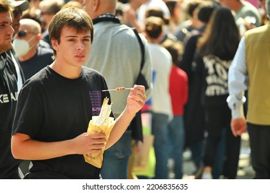 Single Person Walking In Crowded Downtown Eating Italian Street Food Turin Italy September 26 2022