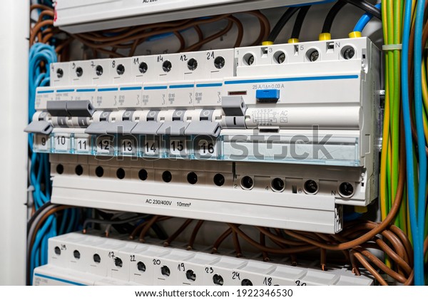 Single phase fuses in OFF and ON position and\
residual current protection in ON position. Many gray switches in a\
row, home fuse box.