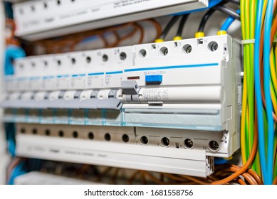 Single Phase Fuses In OFF Position And Residual Current Protection In ON Position. Many Gray Switches In A Row, Home Fuse Box.