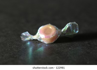 Single Piece Of Candy Wrapped In Colorful Cellophane Wrapper