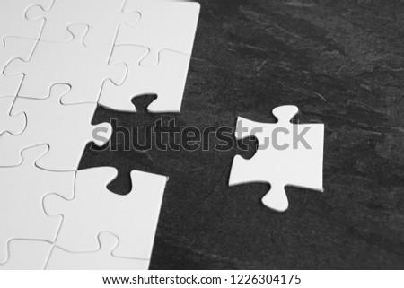 A single piece is missing to complete the puzzle - this lies before the puzzle of the puzzle and waiting to be used - concept with puzzle as a symbol of the final project step