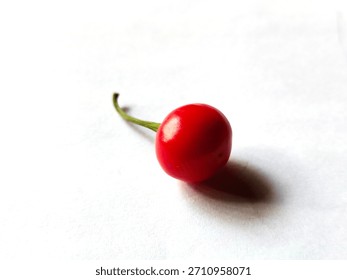 Single piece of red cherry pepper also called pimiento with white background