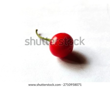 Single piece of red cherry pepper also called pimiento with white background