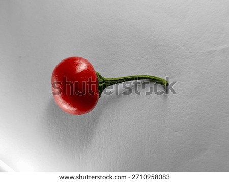 Single piece of red cherry pepper also called pimiento with white background