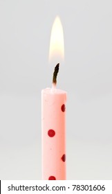 A Single Pink And Spotted Birthday Candle