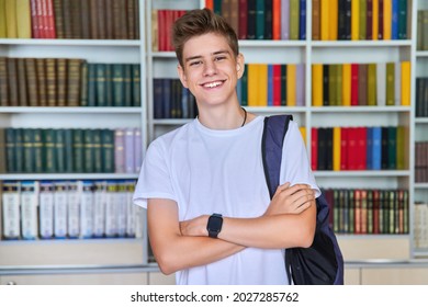 Single portrait of smiling confident male student teenager looking at camera in library - Powered by Shutterstock