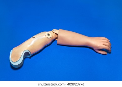 Single Prosthetic Arm In Light Skin Tone Color Over Isolated Blue Background