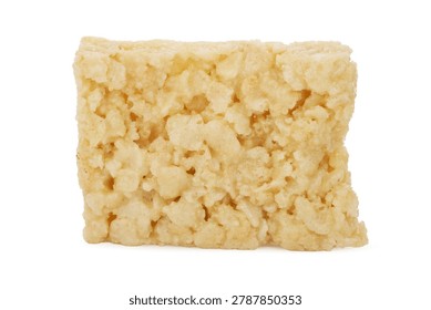 A single rectangular rice cereal treat sits as the sole subject, composed of numerous small, puffed rice grains. This snack features a light golden-brown hue, held together by a translucent, sticky marshmallow binder that creates small, irregular voids and protrusions across the surface. The edges of the rectangle remain sharp and uniform, emphasizing the physical structure of the puffed cereal and sugar-based ingredients. This food object provides a clear view of its material density, surface irregularities, and the adhesive patterns formed during the preparation process. The environment exists within a controlled studio setting, characterized by an absence of architectural or natural surroundings. Soft, diffused light creates a sterile and neutral atmosphere. This setup eliminates directional shadows, resulting in a clinical white backdrop that occupies the entire visual field. The light remains balanced and cool, devoid of any discernible color cast or atmospheric variation. Across the surface, a complex, irregular topography emerges, formed by individual puffed grains bound by a viscous, semi-transparent sugar matrix. These materials create a matte finish punctuated by small, cavernous voids and raised, rounded protrusions. The interplay between the toasted, cereal-based textures and the smooth, adhesive bridges provides a tactile, multi-layered appearance, while uniform light highlights the granular density and the delicate, honeyed color palette of the baked forms.