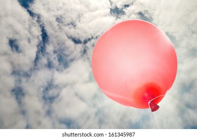 Single Red Balloon Flying To Sky With Clouds