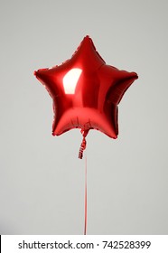 Single Red Big Star Metallic Balloon Object For Birthday On A Grey Background