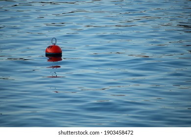 A Single Red Buoy in the Sea 
