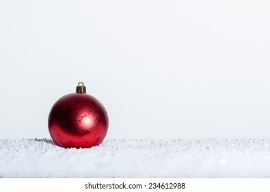 Single Red Christmas Ornament On Snow Room For Text