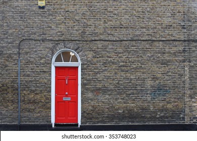 Single Red Door On Brick Wall