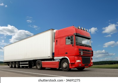 Single Red Lorry With White Trailer Over Blue Sky On The Road.