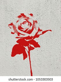 Single Red Rose Made In Graffiti Style With Stencil Effect Painted On White Textured Concrete Wall With Copy Space.