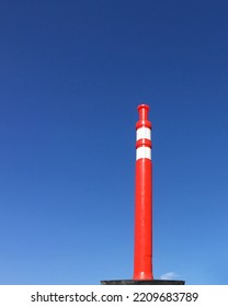 Single Red And White Traffic Pylon Under Blue Sky