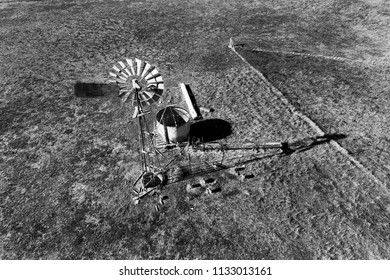 Single Remote Self-winding Windmill On A Cattle Farm In The Middle Of Nowhere - Australian Outback With Arid Dry Climate And Scarce Grass.