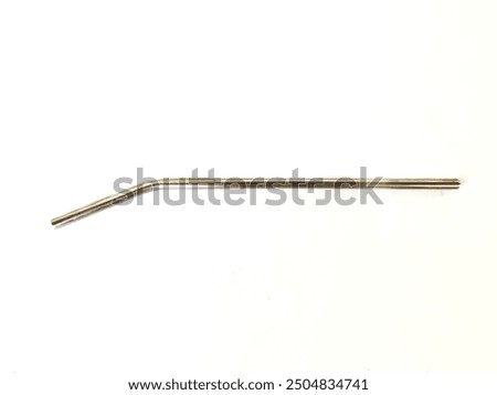 Single reusable steel straw or stainless steel straw or metal straw isolated on white background. Zero waste concept, eco friendly product as alternative to plastic straws. Top view