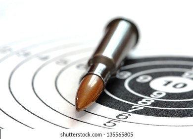 Single Rifle Bullet On Paper Target For Shooting Practice