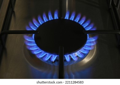 A Single Ring Of A Lit Gas Hob Burning With Blue Flames