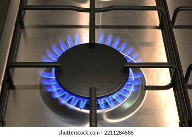 A Single Ring Of A Lit Gas Hob Burning With Blue Flames