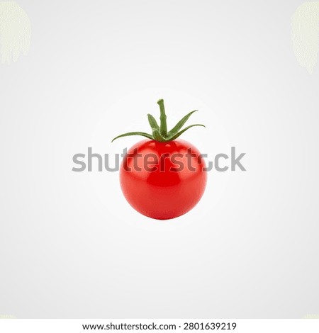Single ripe red cherry tomato with green stem and leaves on white background