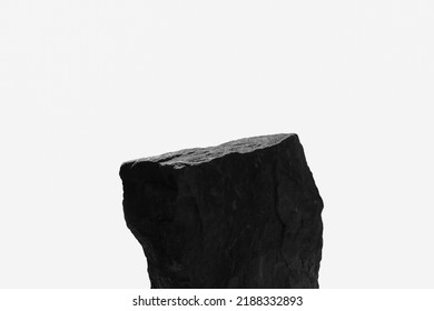 A Single Rock Boulder, Showing a Sun Lit Top Ledge with Close Detail to the Natural Indents of the Ancient Stone, Isolated on a White Background.