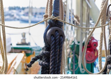 Single rope and block and tackle sailing equipment on an old sailing barge, black rope.