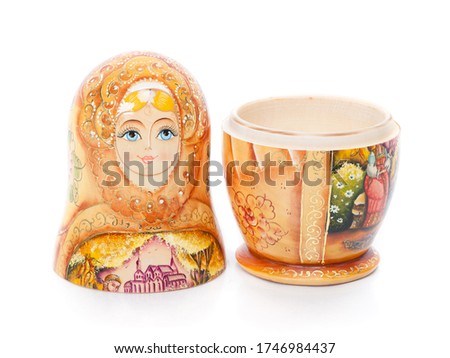 Single Russian nesting doll (also named as Matrioshka) isolated over white background. Wooden doll souvenir.