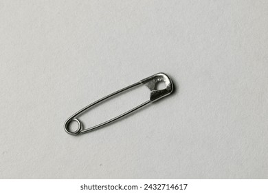 Single safety pin isolated on a white background