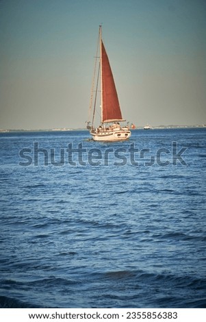                         A single sail boat on the sea at Lisabon.