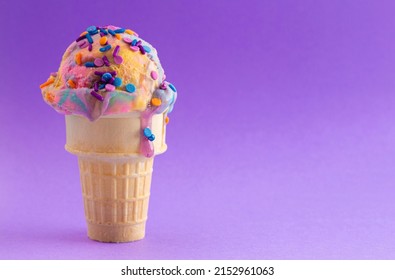 A Single Scoop of Unicorn Colored Ice Cream in a Cone - Shutterstock ID 2152961063